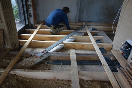 a floorer laying and installing a floor in a building