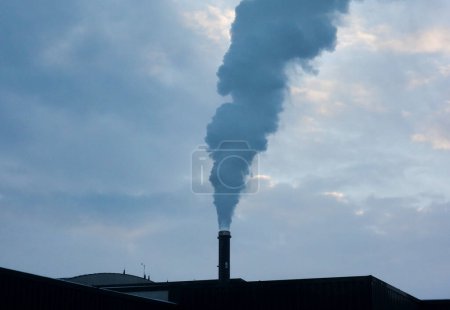 Photo for Smoking factory chimney or smokestack, pollutant emissions and climate change - Royalty Free Image