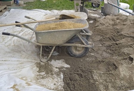 Photo for Wheelbarrow for transporting and moving carriage at the construction site - Royalty Free Image