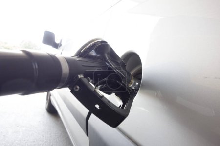refueling a car with fuel for driving, transport and mobility