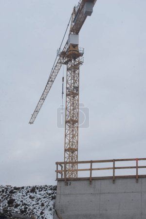Construction crane in building industry, heavy machine at construction site