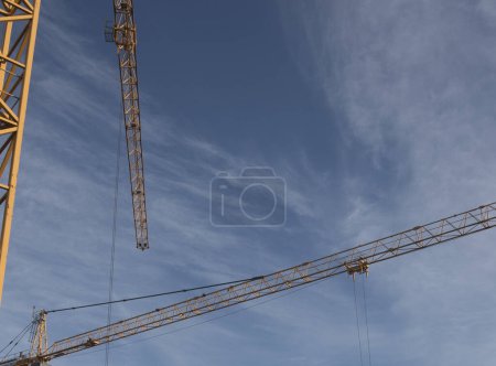 Construction crane in building industry, heavy machine at construction site
