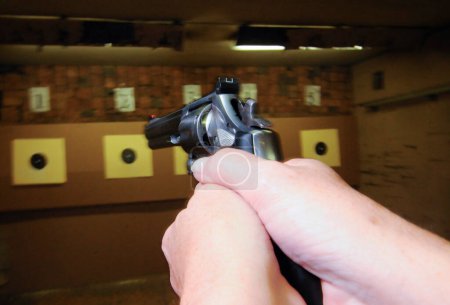 Photo for Target shooter at a shooting range, indoor sports with weapon - Royalty Free Image