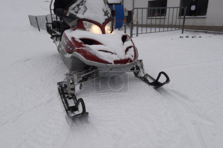 a snowmobile, a vehicle designed for winter travel on snow