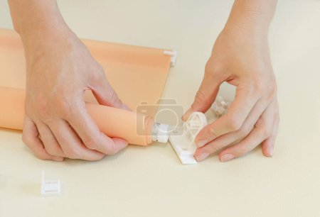Photo for Assembly of roller blinds. Women's hands are assembling roller blinds - Royalty Free Image