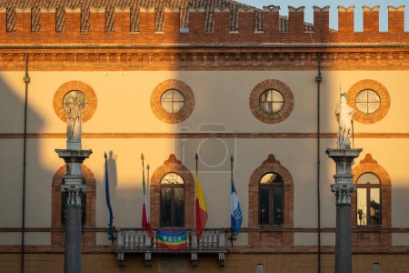 Photo for The town hall of Ravenna from the balcony 4 flags are displayed, European, Italian, regional and a city flag,two staue of Saint apollinare and Vitalis - Royalty Free Image