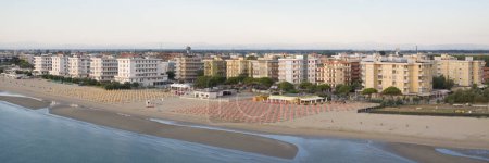 Drone view of sandy beach with umbrellas and gazebos.Summer vacation concept.Lido Adriano town,Adriatic coast, Emilia Romagna,Italy.