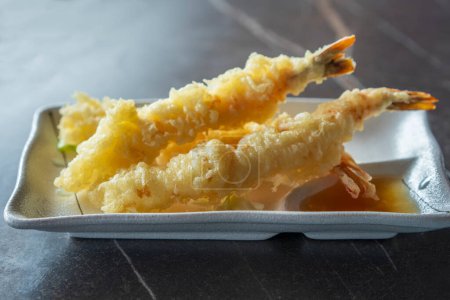 Close up view of prepared Japanese prawns tempura recipe with ginger ponzu sauce.