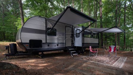 Photo for Travel trailer set up with awnings out at a campsite at Jordan Lake North Carolina - Royalty Free Image