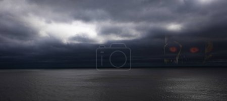Photo for Dangerous ocean storm with a skull in the clouds - Royalty Free Image