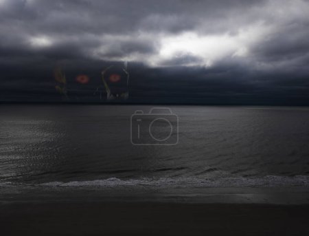 Photo for Harbinger rising behind a storm approaching over the ocean - Royalty Free Image