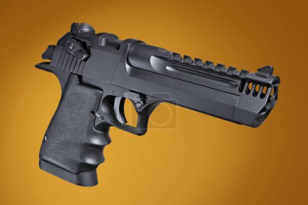 Foto de Semi auto handgun quartering on an orange background - Imagen libre de derechos