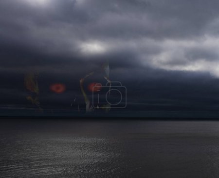 Photo for Skull waiting for vvictims in a storm over the ocean - Royalty Free Image