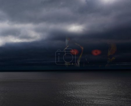 Photo for Skull in the clouds of a storm that is over the ocean - Royalty Free Image
