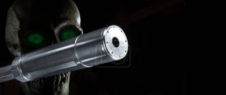 Photo for Skull with green eyes behind a silencer - Royalty Free Image