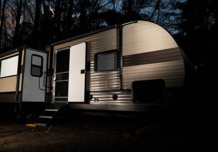 Headlights and flashlight on an unlocked and open RV inviting theft after the sun has set