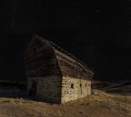 Photo for Starry skies on a clear night above an old stable - Royalty Free Image