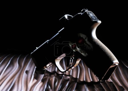 Photo for Human skull with glowing red eyes on the silhouette of a ghost gun - Royalty Free Image