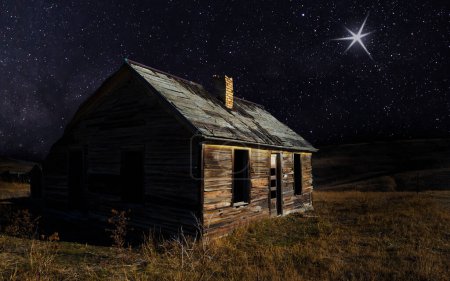 Shining light on a starry night above an abandoned house