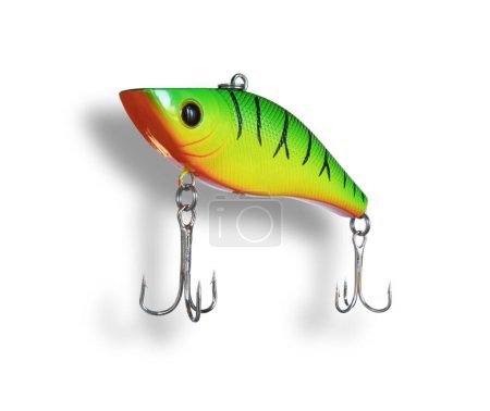 Dropshadow behind an artificial lure for bass fishing that is colored yellow, orange and green with a pair of treble hooks.