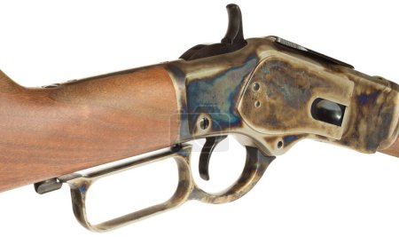 Isolated lever and receiver on a lever action rifle that are color casehardened on a wood stock. 