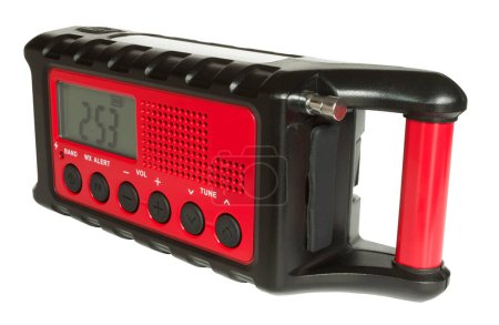 Weather radio that is battery powered, but has a solar cell and hand crank backup, in addition to a flashlight, all on an isolated background.