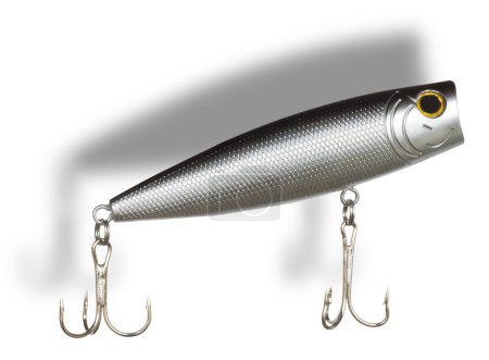 Dropshadow behind and isolated silver, gray and black fishing bait designed to run on the surface of the water. 