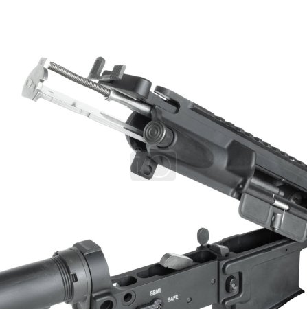 Bolt carrier group that converts an AR-15 so it can chamber .22 rimfire ammunition sliding into the gun's upper receiver isolated in a studio shot.