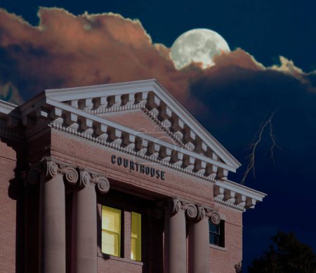 Under cover of the evening the late night lights are burning in the county courthouse as special deals are made with the moon rising above and lightning striking.