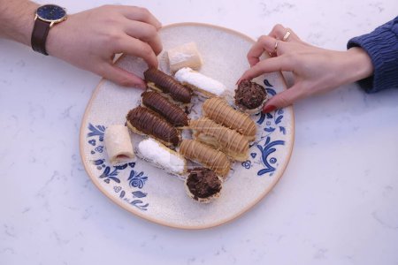 Eclairs with chocolate topping, delicious chocolate small cake, ekler pastry