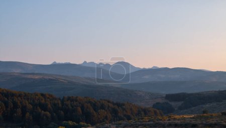 Photo for Sunset view of the northern Sierra de Gredos from Hoyos del Espino, Avila, Spain. Silhouette of the peaks of the formation of the circus of Gredos, the Almanzor peak stands out for its height. - Royalty Free Image