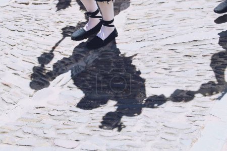 Shadow of a traditional dancer on a cobbled floor. Dance that takes place in April at the religious festivals of La Rabida, in Sanlucar de Guadiana, Huelva, Spain.