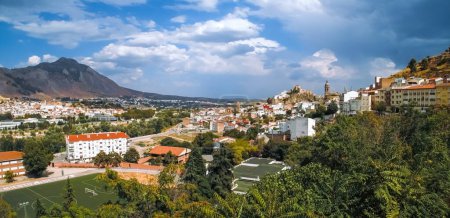 Panoramic view of Loja from the west, Sylvania viewpoint. View of the houses and their churches embedded in the valley of the Genil River. Town surrounded by crop fields and mountains. Loja, Spain.