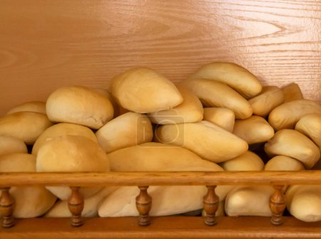 Traditional Spanish style bread rolls. Bread for sandwiches displayed on a shelf for sale. Bakery in Sanlucar de Guadiana, Andalusia, Spain.