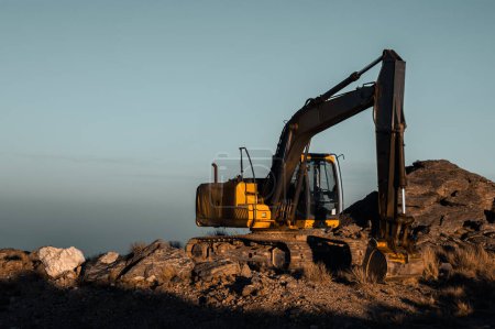 Photo for Shaping the Peaks: Dynamic View of an Excavator at Work in the M - Royalty Free Image