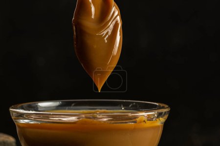 Photo for Glass bowls with Argentine dulce de leche with dark background - Royalty Free Image