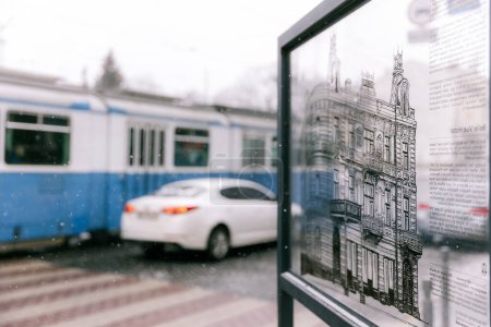 Photo for 04.12.2022 Vinnitsa, Ukraine: view of the city central of Vinnytsia with blue train on background, selective focus, noise effect - Royalty Free Image