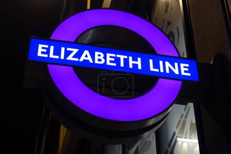 Photo for Illuminated Elizabeth Line purple London Underground tube station sign - Royalty Free Image