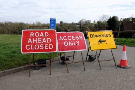 Road ahead closed, access only and diversion signs