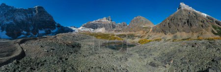 Panoramic aerial view of Wenkchemna Peak and Eiffel Lake with some snow in autumn, with yellow trees. Rocky Mountains, Canada