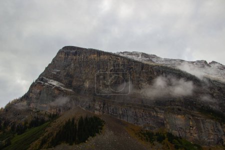 Spectacular view of Fairview Mountain on a cloudy day with autumn fog, Lake Louise, Canada.