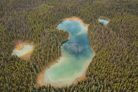 Vue aérienne des lacs de Lorraine, entourés de milliers d'arbres, le ciel se reflète dans les lacs par une journée nuageuse. Parc national Jasper, Canada.