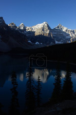 Valley of Ten Peaks near Moraine Lake on a sunny autumn day with snow on the mountain. Nice reflection of the mountains on a sunny morning.