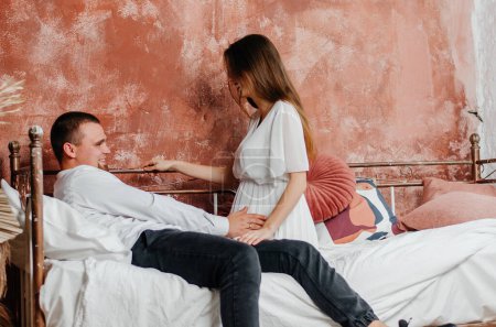 Photo for Pregnant woman with man in bed - Royalty Free Image