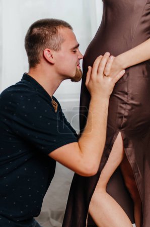 Photo for A man caresses the stomach of a pregnant girl - Royalty Free Image