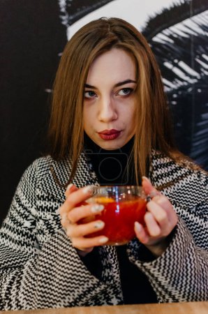 Photo for The girl drinks fruit tea - Royalty Free Image