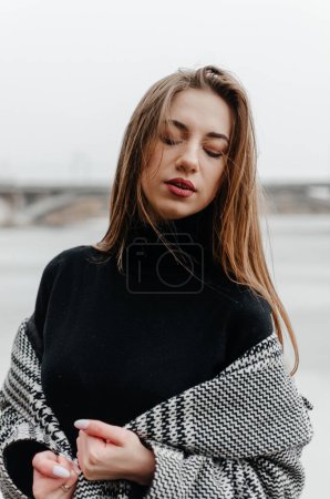 Photo for Portrait of a beautiful girl in a black sweater and a gray coat - Royalty Free Image