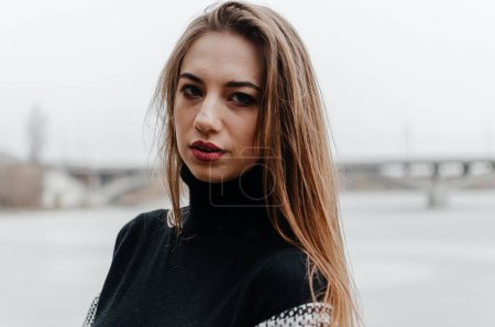 Photo for Portrait of a beautiful girl in a black sweater and a gray coat - Royalty Free Image