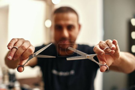 Téléchargez les photos : Main de barbier tester la netteté de la lame avant de couper
. - en image libre de droit