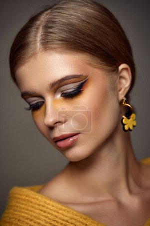 Photo for Beauty blonde model girl with fashionable creative make-up, bright eye line. Creative yellow eye makeup ideas. - Royalty Free Image